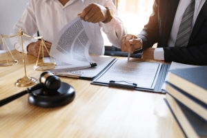 Commercial real estate lawyers with legal gavel and scales of justice negotiating contract